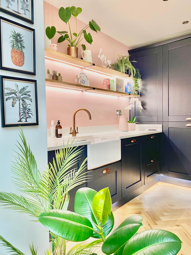 Belfast kitchen sink on indigo shaker cabinets and house plants